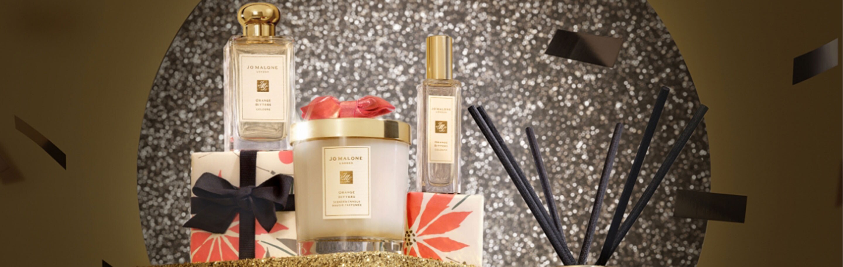 Jo Malone London Orange Bitters Collection Candle Cologne with red and white bows on red and white candy canes